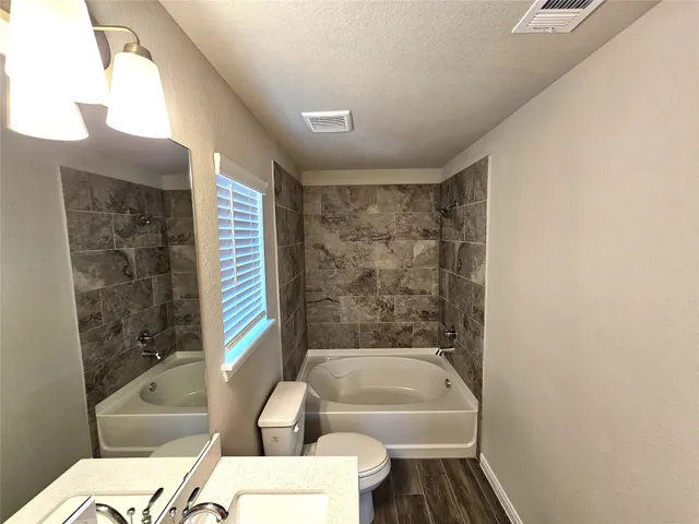 a bathroom with a bathtub and shower