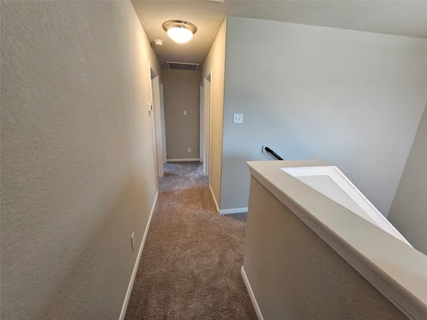 a view of a hallway with washer and dryer