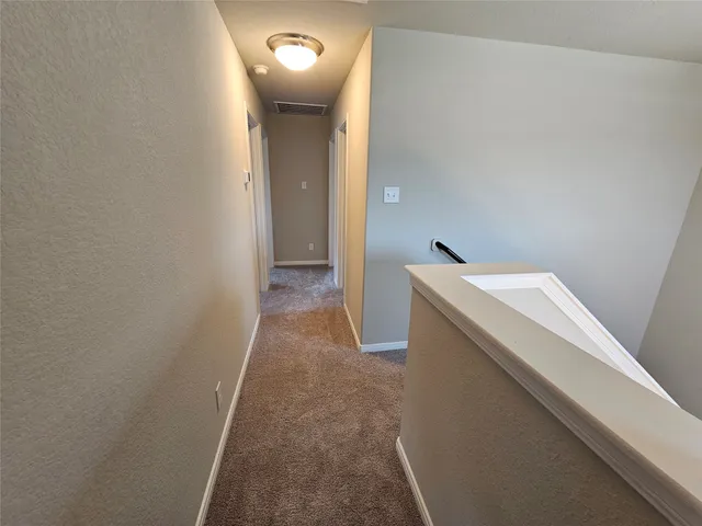 a view of a hallway with washer and dryer