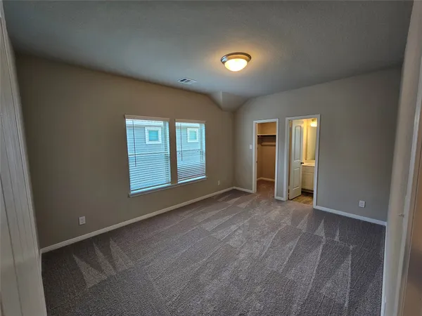 an empty room with windows and closet