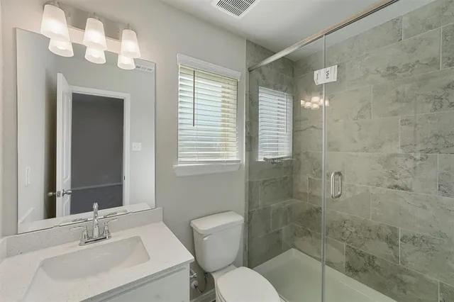 a bathroom with a sink toilet and shower