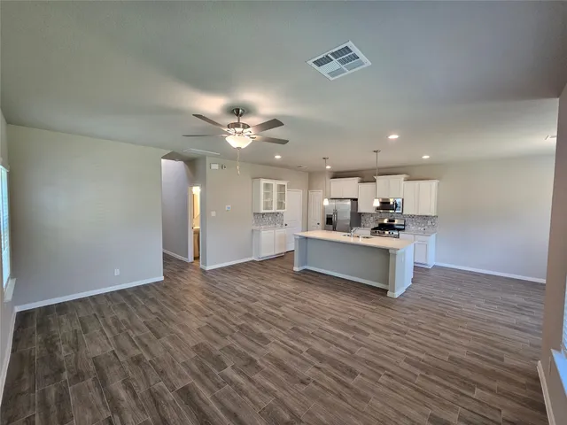 a view of kitchen with cabinets and wooden floor