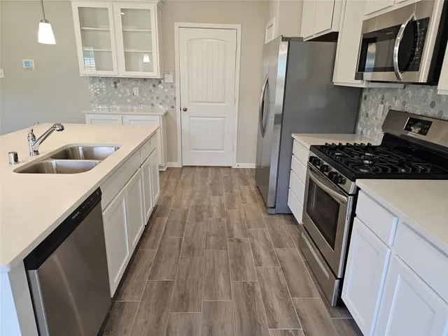 a kitchen with a sink stove and refrigerator