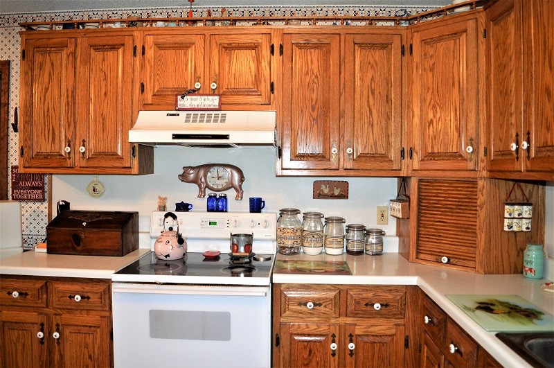 505 W Road Morrison, TN 37357 - Photo 15 of 44 a kitchen with granite countertop a stove top oven a sink dishwasher and cabinets with wooden floor