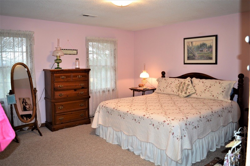 505 W Road Morrison, TN 37357 - Photo 21 of 44 a bedroom with a bed a dresser and painting on the wall