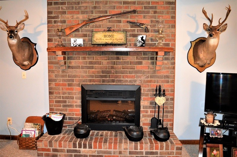 505 W Road Morrison, TN 37357 - Photo 10 of 44 a living room with a fireplace and a flat screen tv