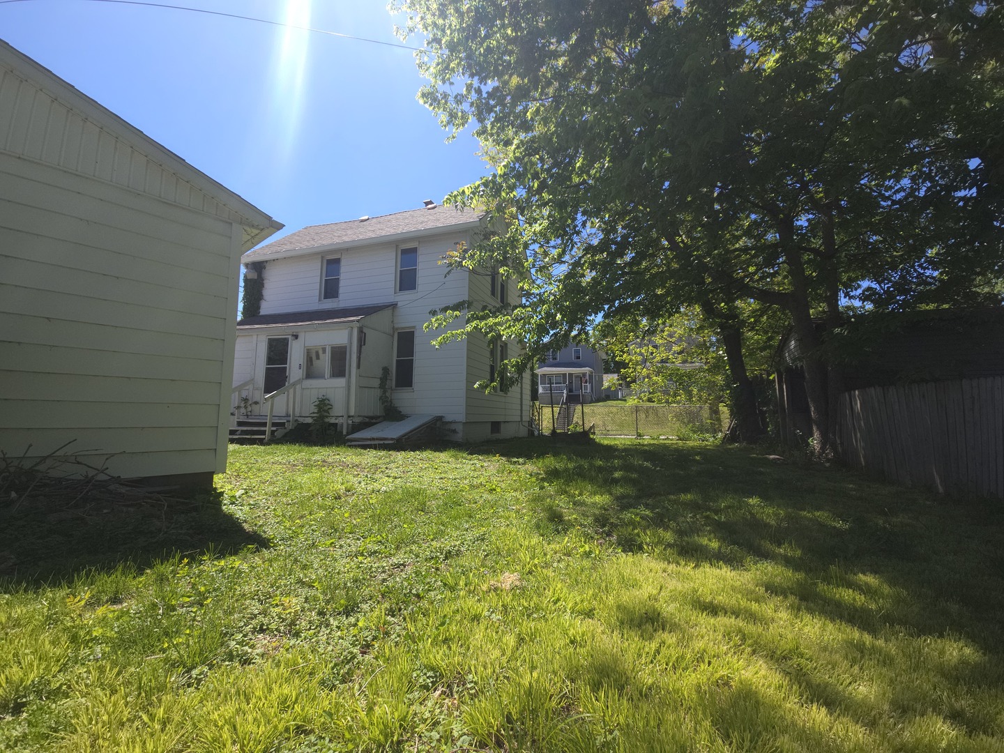 1306 17th Street Moline, IL 61265 - Photo 4 of 14 a backyard of a house with a garden and tree