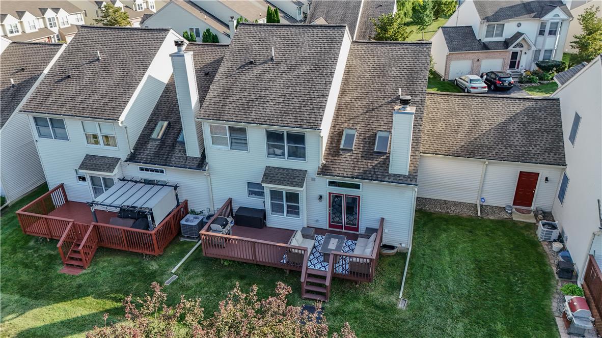 237 Ridings Circle Macungie, PA 18062 - Photo 10 of 70 An elevated perspective showcases the rear facade, featuring dual-level structures with private wooden decks.