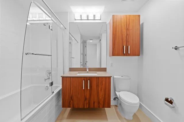 a bathroom with a sink double vanity mirror and a bathtub