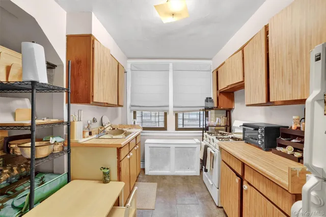 a kitchen with a sink stove and refrigerator