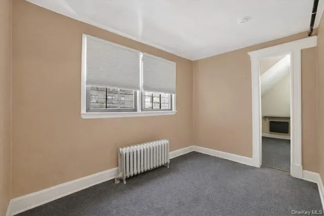 a bedroom with a bed and a potted plant