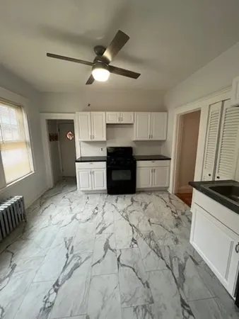 a large kitchen with a stove and a refrigerator