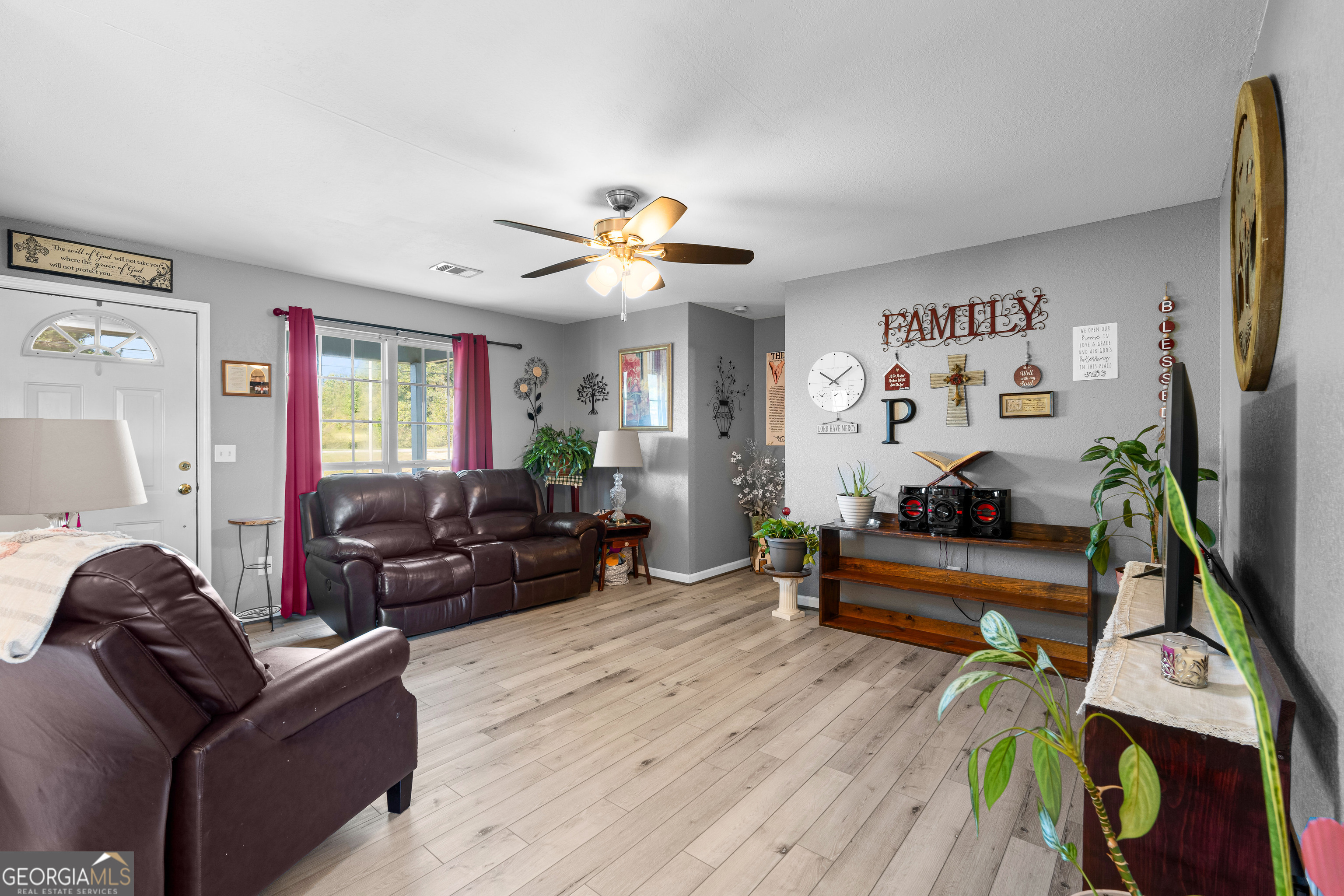 3939 Bevis Road Franklin, GA 30217 - Photo 12 of 40 a living room with furniture gym equipment and a flat screen tv
