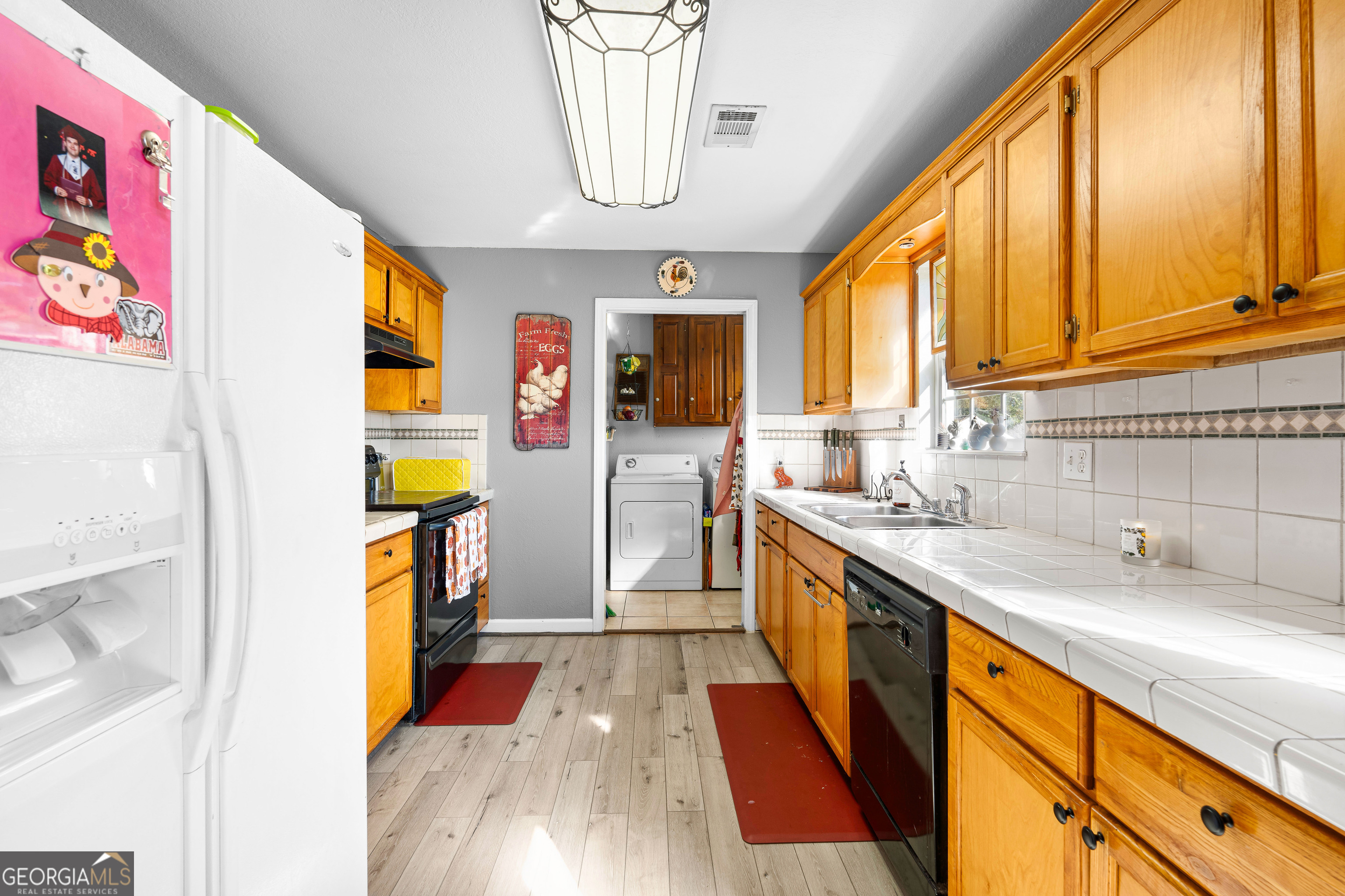 3939 Bevis Road Franklin, GA 30217 - Photo 16 of 40 a kitchen with stainless steel appliances granite countertop a sink and a refrigerator