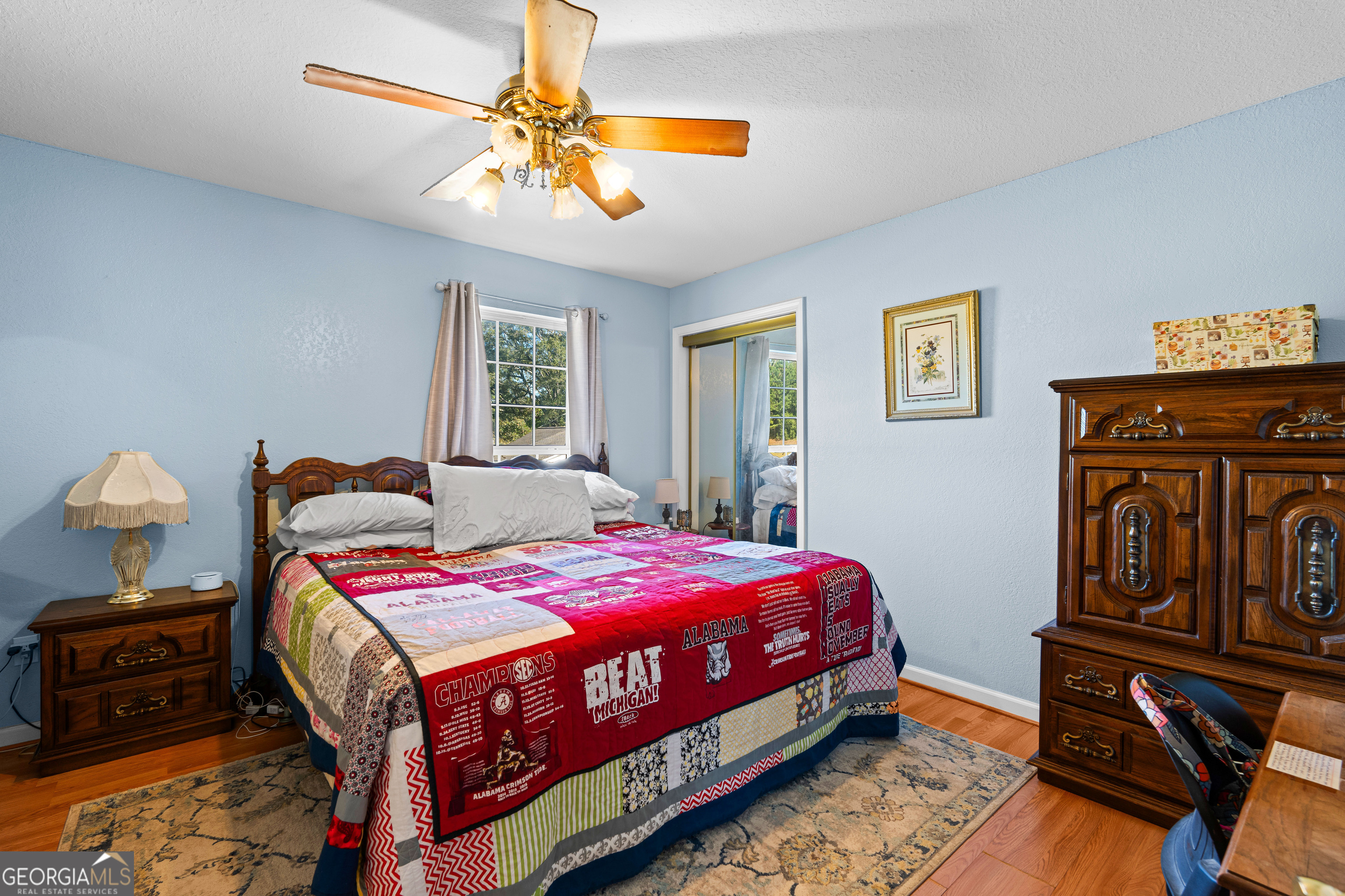 3939 Bevis Road Franklin, GA 30217 - Photo 23 of 40 a bedroom with a bed a dresser with wooden floor