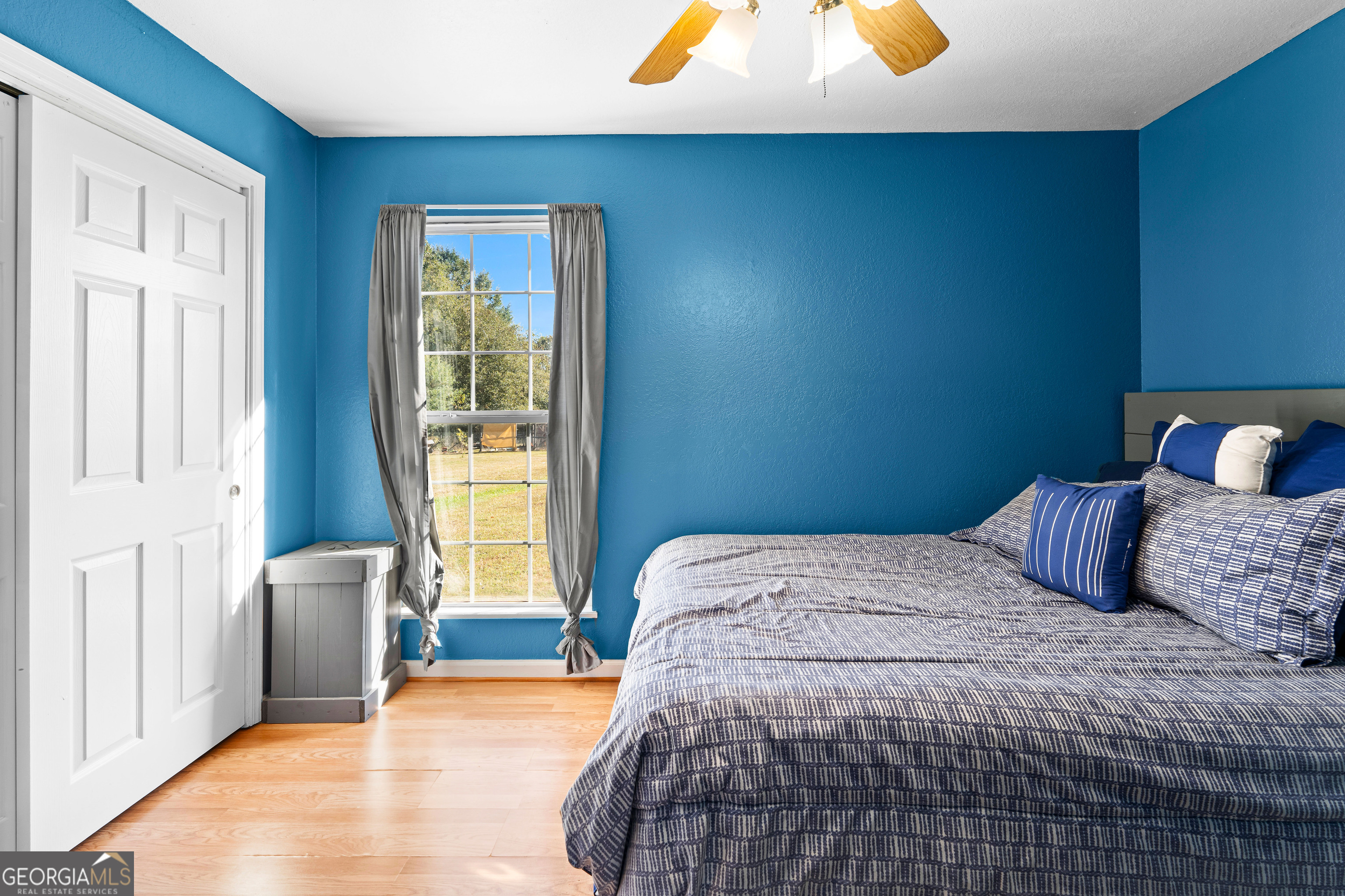 3939 Bevis Road Franklin, GA 30217 - Photo 27 of 40 a bedroom with a bed and wooden floor