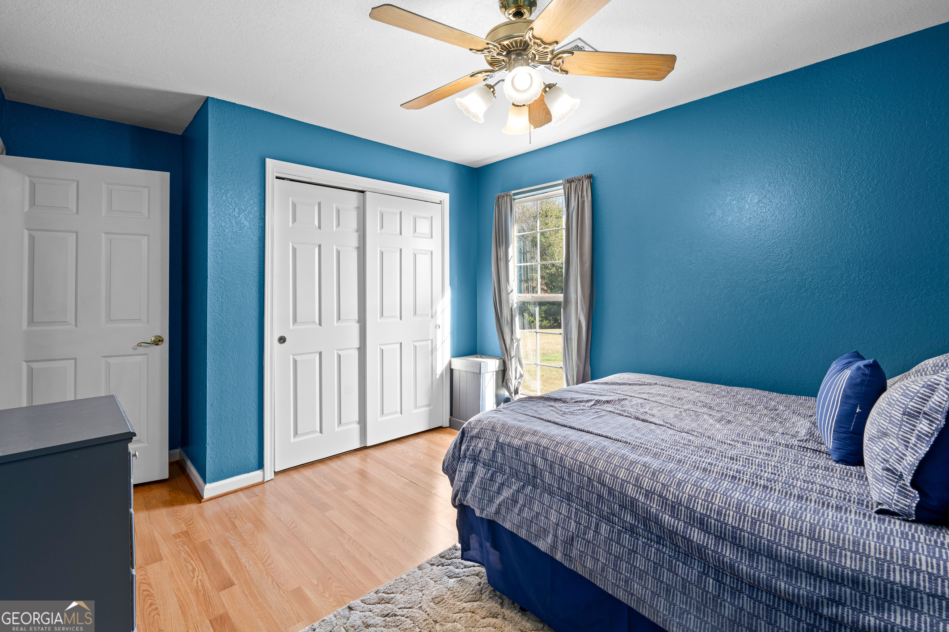 3939 Bevis Road Franklin, GA 30217 - Photo 28 of 40 a bedroom with a large bed and a chandelier