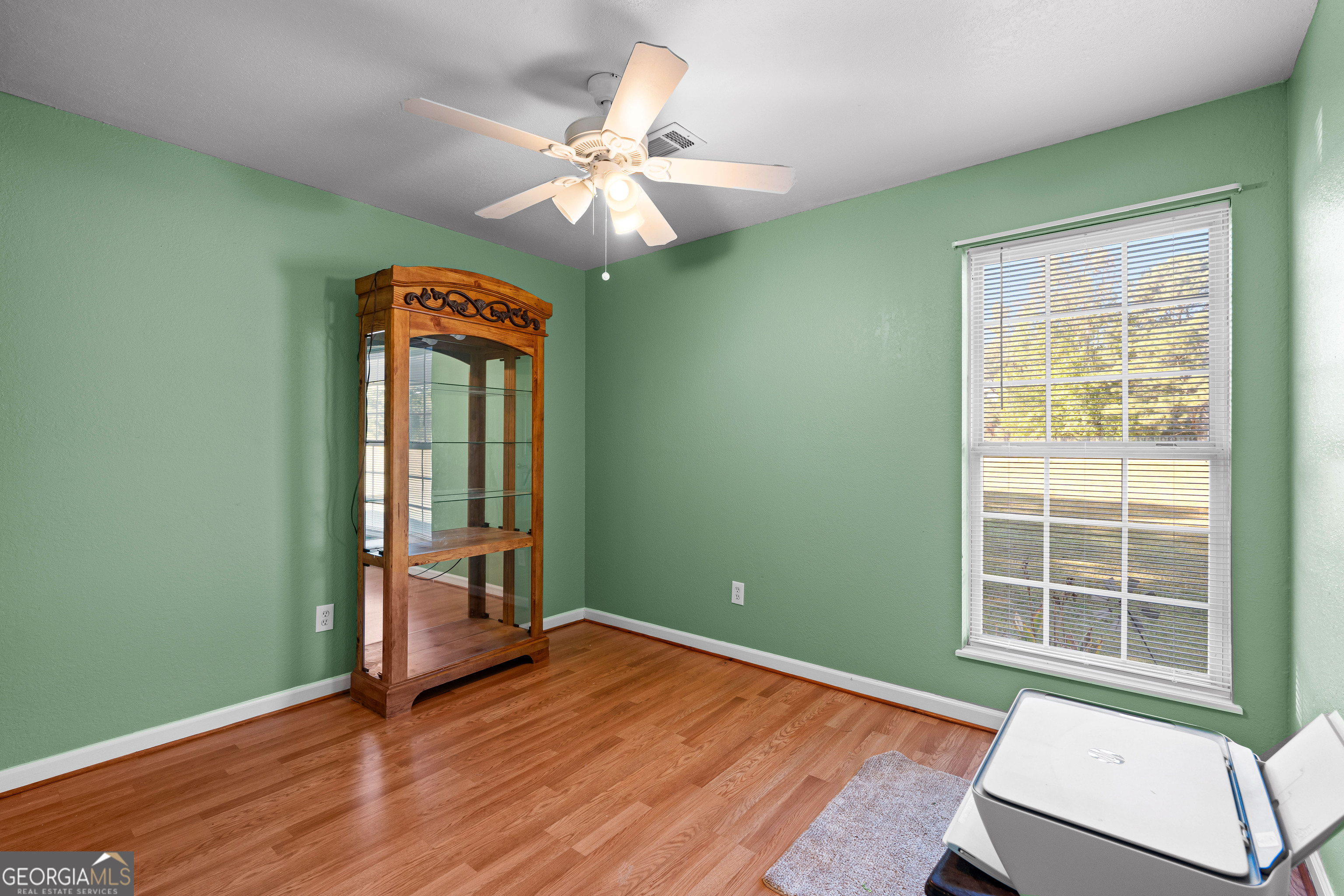3939 Bevis Road Franklin, GA 30217 - Photo 29 of 40 an empty room with window wooden floor and fan