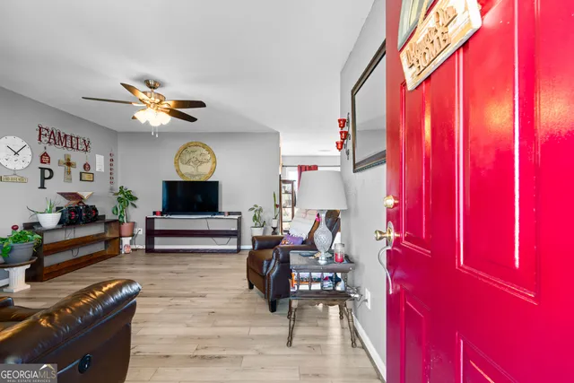 a living room with furniture a fireplace and a window