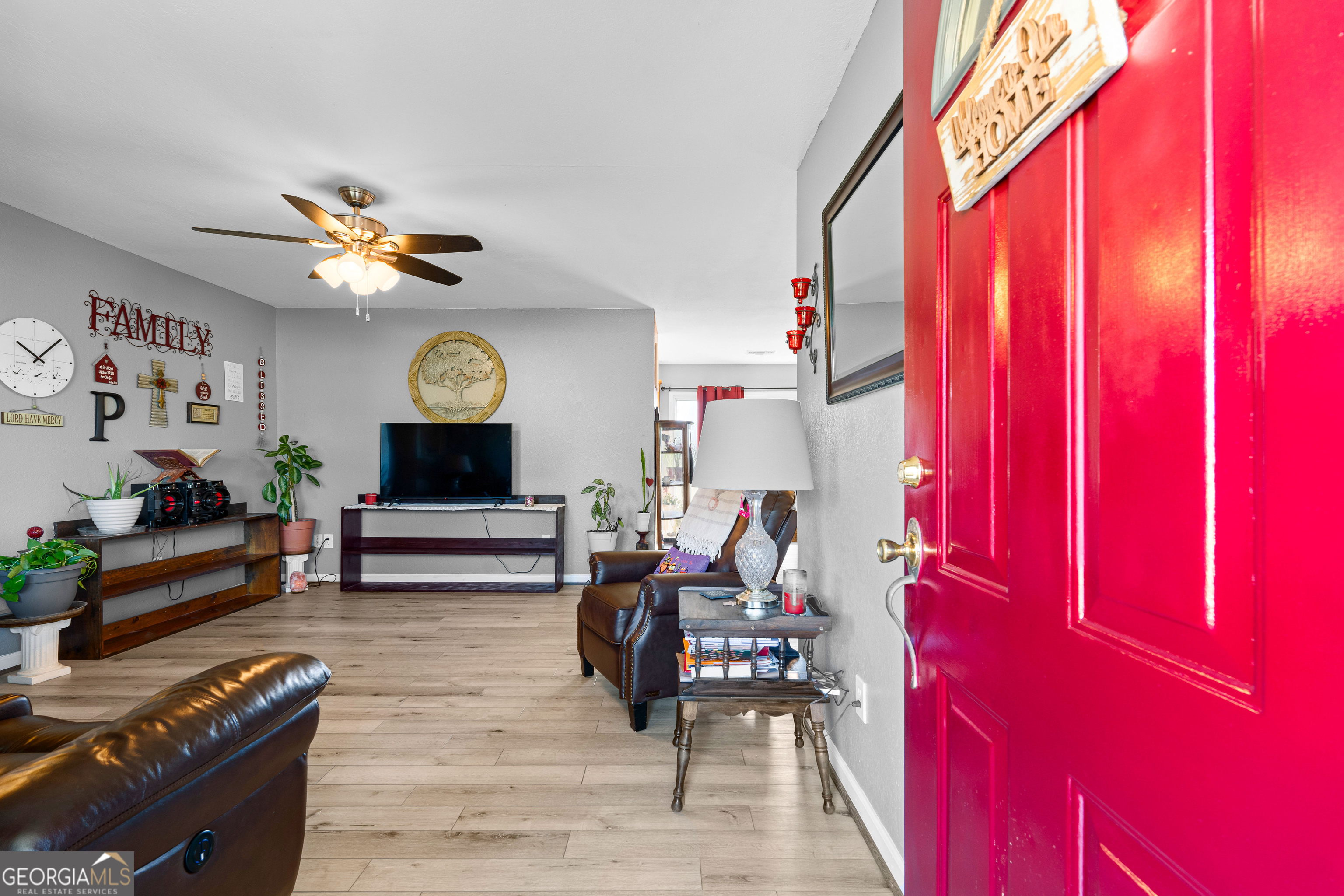 3939 Bevis Road Franklin, GA 30217 - Photo 7 of 40 a living room with furniture a fireplace and a window