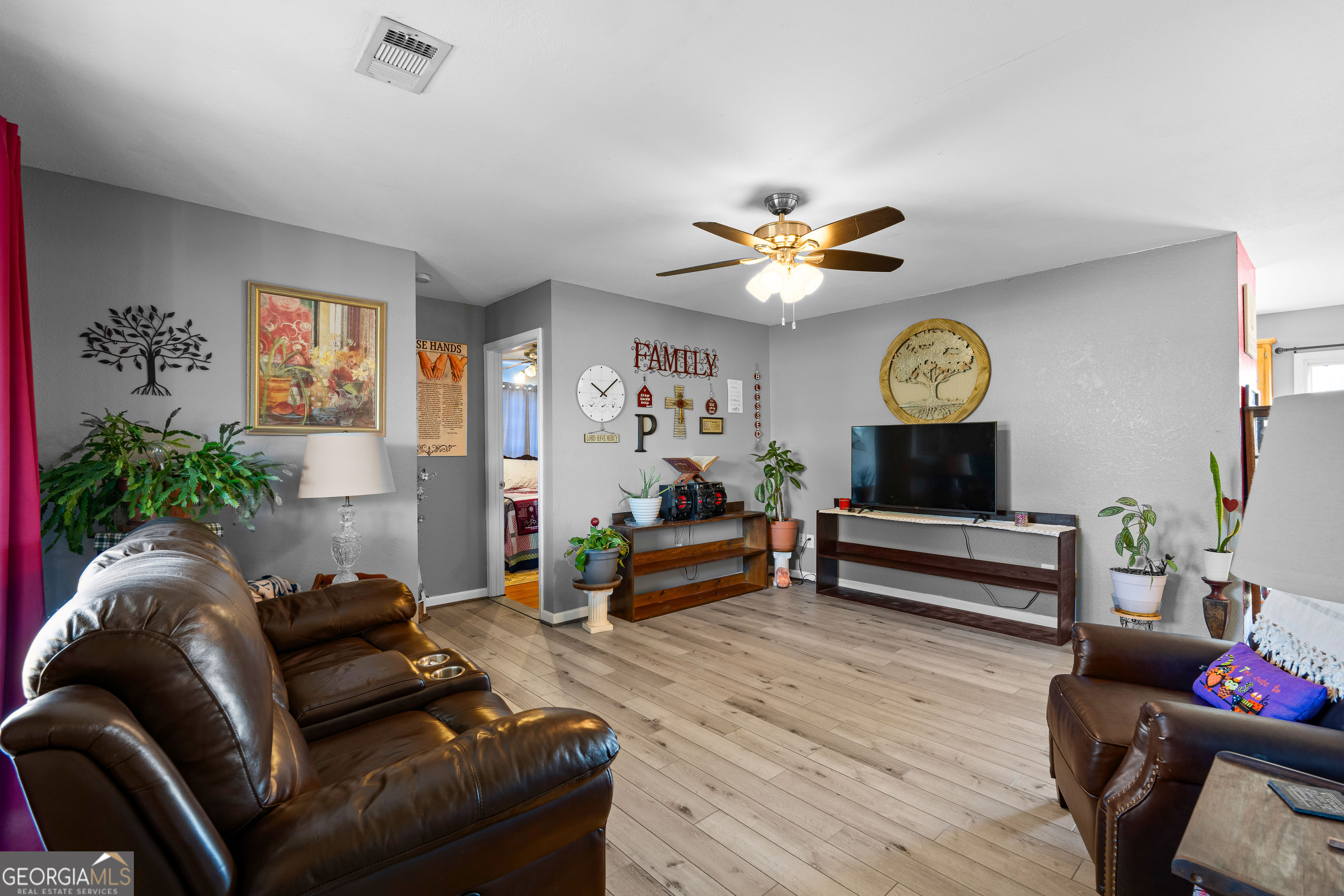 3939 Bevis Road Franklin, GA 30217 - Photo 9 of 40 a living room with furniture and a clock