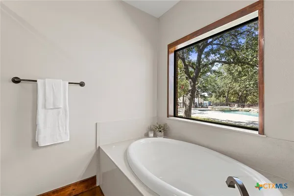 a kitchen with granite countertop cabinets stainless steel appliances and a wooden floor