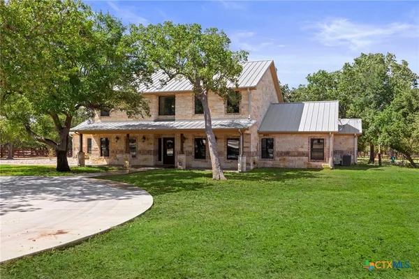 a view of a house with a yard porch and sitting area