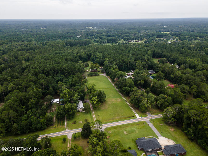 45186 Bismark Road Callahan, FL 32011 - Photo 54 of 54 an aerial view of residential houses with outdoor space and trees