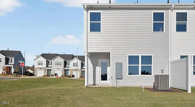 an aerial view of a house with a yard and lake view