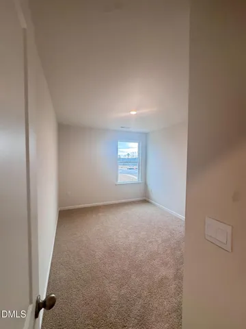 a view of an empty room and a window