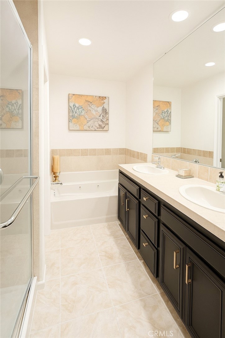 16706 Tim Lane Van Nuys, CA 91406 - Photo 11 of 16 a spacious bathroom with a tub sink and a mirror