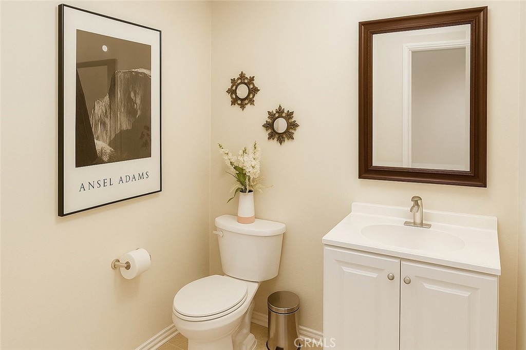 16706 Tim Lane Van Nuys, CA 91406 - Photo 13 of 16 a bathroom with a toilet sink and mirror