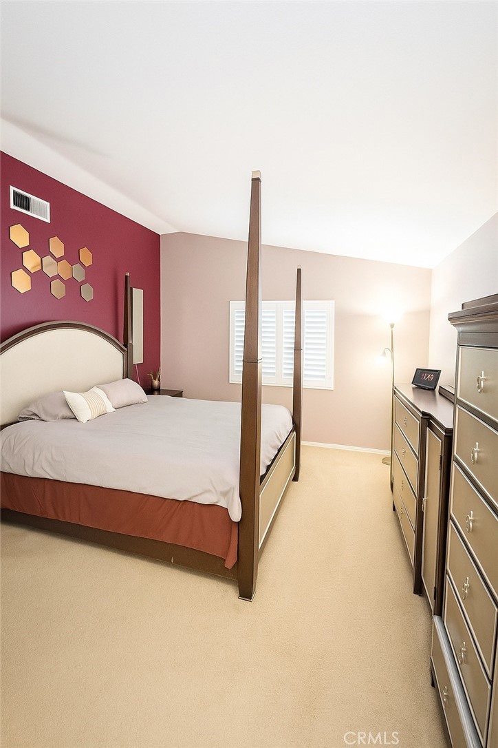 16706 Tim Lane Van Nuys, CA 91406 - Photo 10 of 16 a spacious bedroom with a bed and a flat screen tv