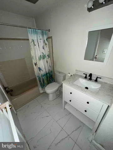 a bathroom with a double vanity sink mirror and toilet