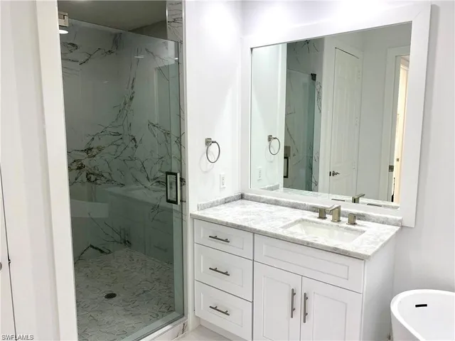 a bathroom with a shower and a sink