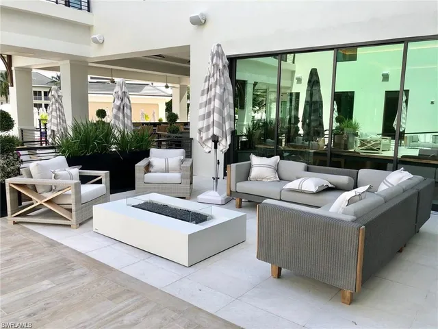 a living room with furniture and large windows