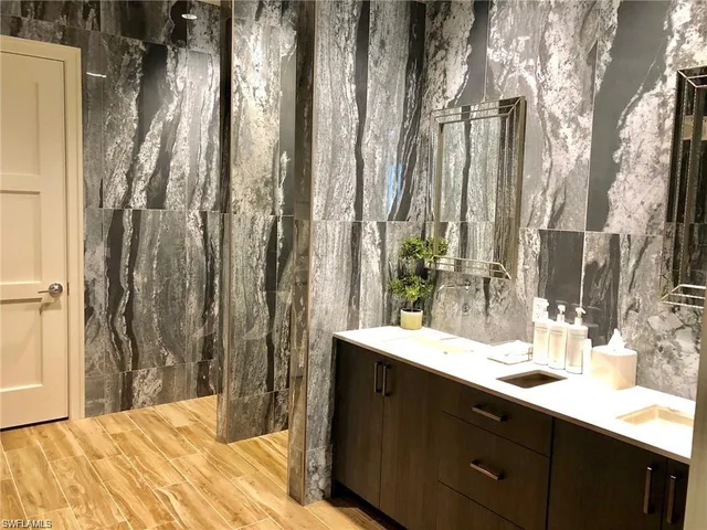 a bathroom with a double vanity sink and a mirror