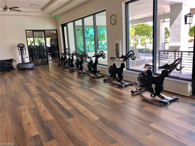a view of a room with gym equipment and floor to ceiling window