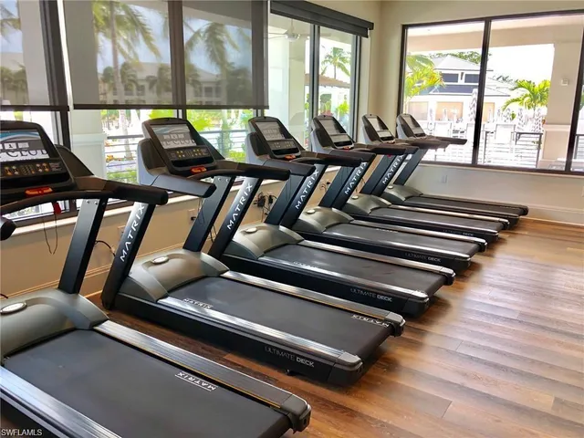 a very nice looking room with many windows and furniture