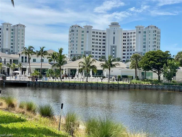 a view of residential houses with outdoor space and lake view