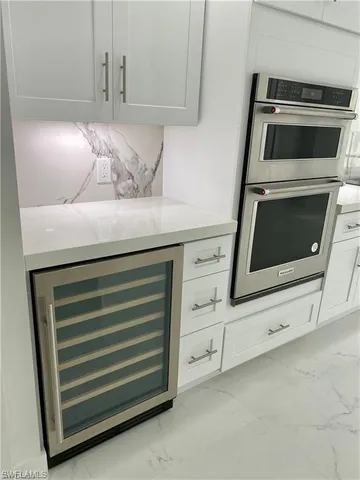 a kitchen with white cabinets and a stove