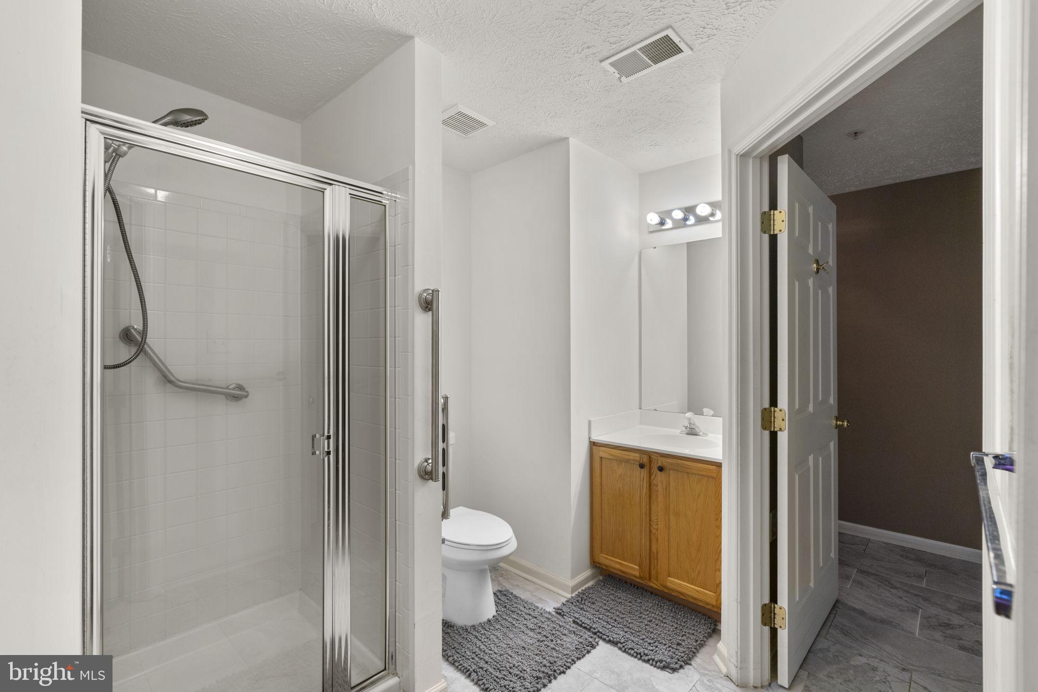9713 Reese Farm Road, Unit 9713 Owings Mills, MD 21117 - Photo 17 of 30 a bathroom with a toilet a sink and shower
