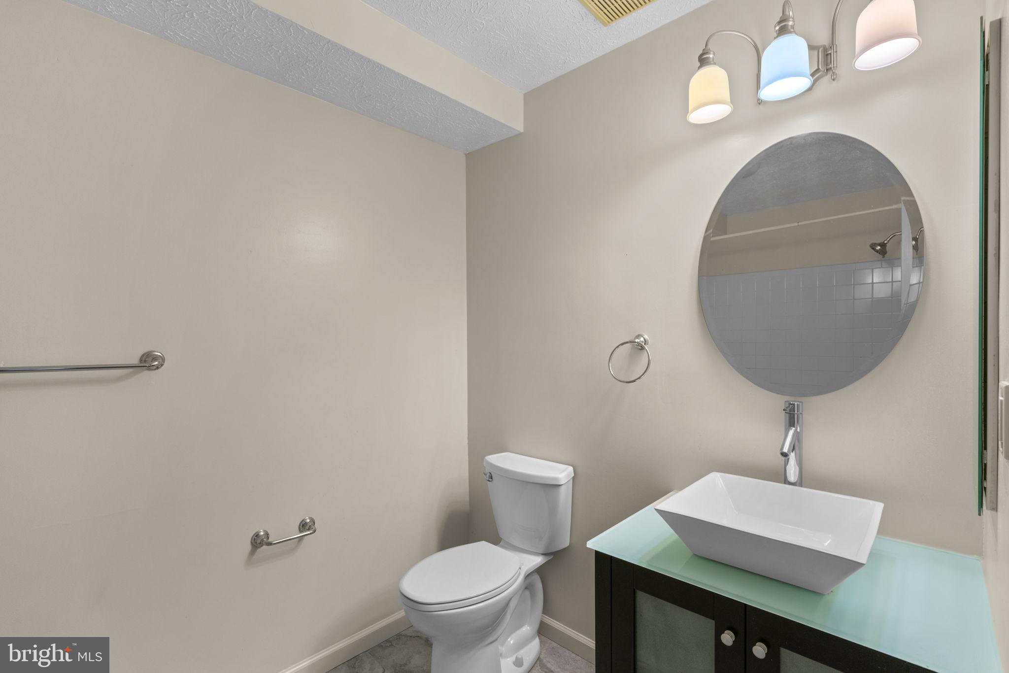 9713 Reese Farm Road, Unit 9713 Owings Mills, MD 21117 - Photo 19 of 30 a bathroom with a toilet a sink and mirror