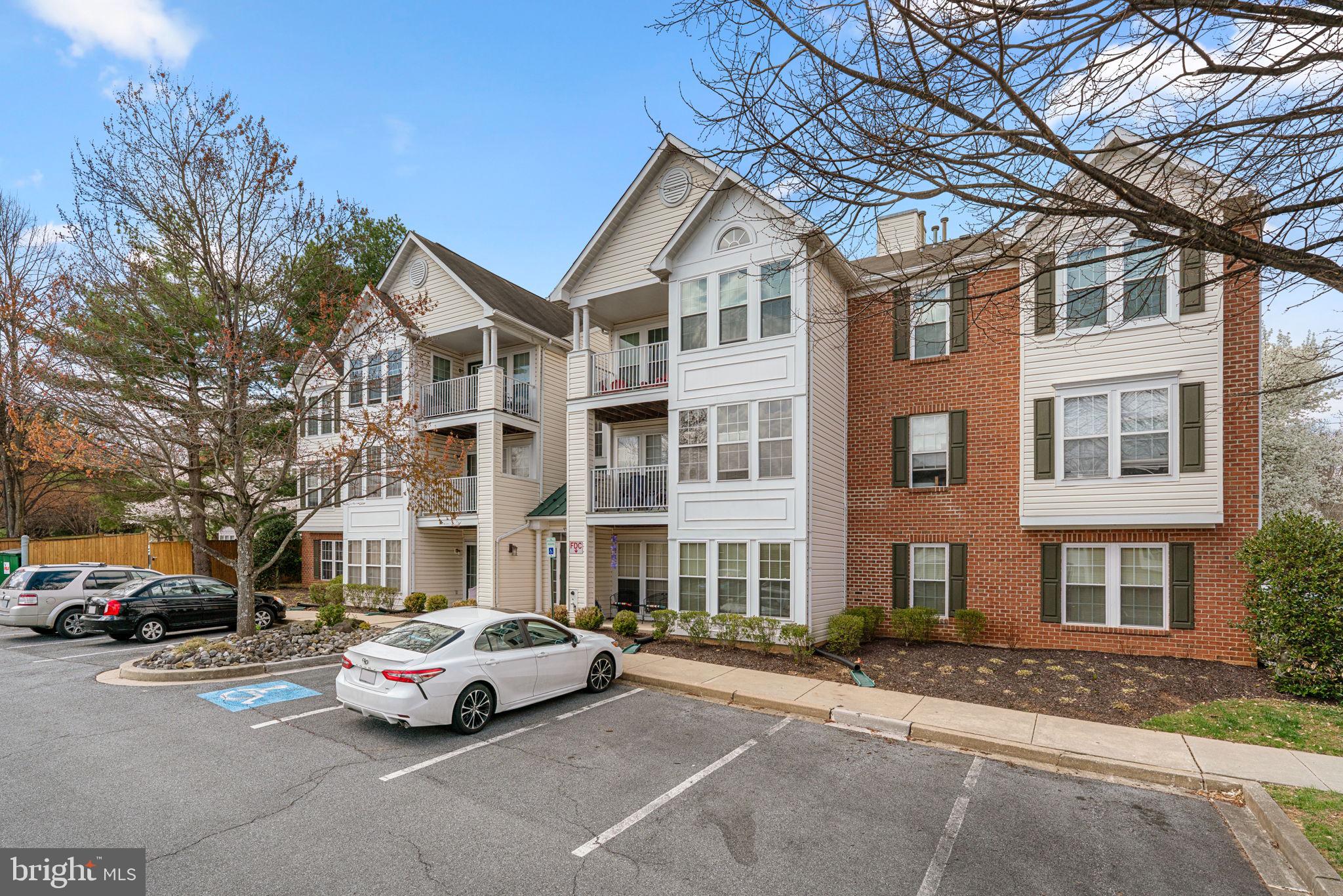 9713 Reese Farm Road, Unit 9713 Owings Mills, MD 21117 - Photo 2 of 30 a car parked in front of a brick building