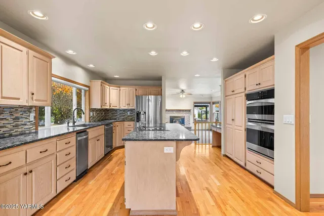 a dining room with furniture a chandelier and wooden floor