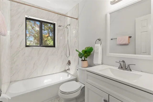 a bathroom with a toilet a sink and a bath tub