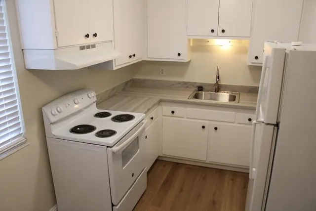 a white refrigerator freezer sitting inside of a kitchen