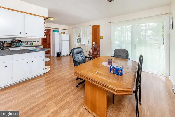 a view of a dining room with furniture a chandelier and wooden floor