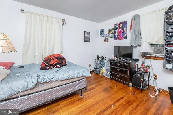 a bedroom with furniture and a wooden floor