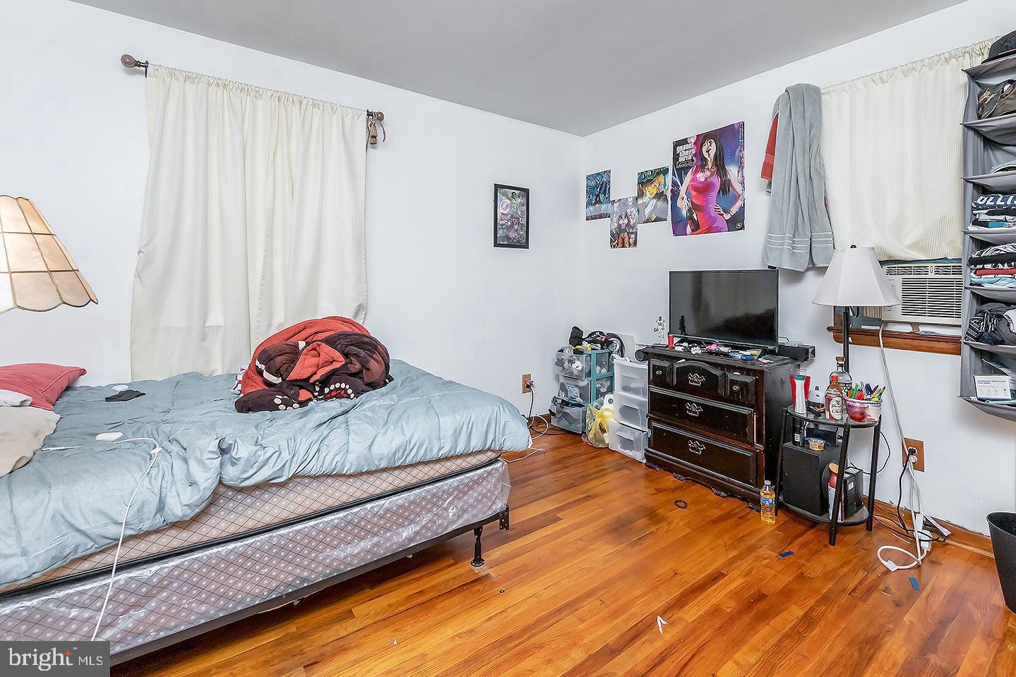 217 University Boulevard Glassboro, NJ 08028 - Photo 15 of 23 a bedroom with furniture and a wooden floor